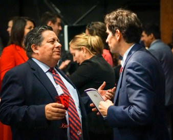 Dean Saúl Jiménez-Sandoval (right) talks with Peter Robertson of the Alumni Association