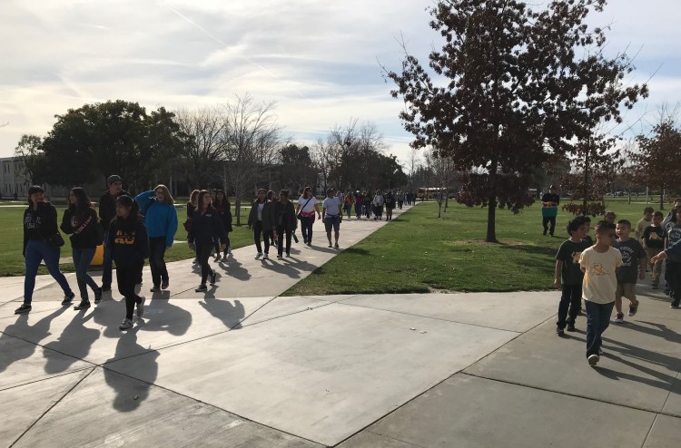 Elementary school students arrive on campus for the Peach Blossom Festival.