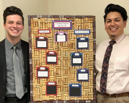 Christopher Rodriguez and Christian Cabral with the competition score board.