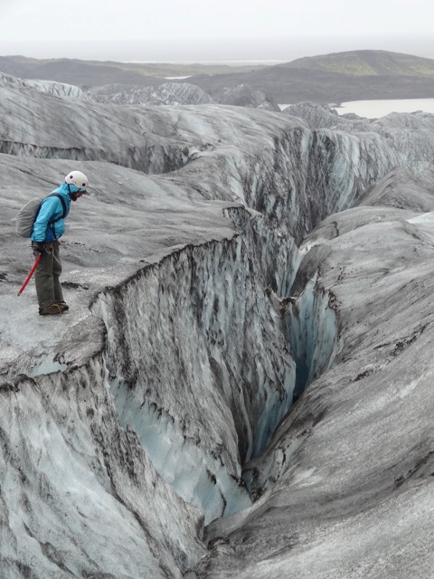 Jes Therkelsen looks down a crevasse in Iceland.