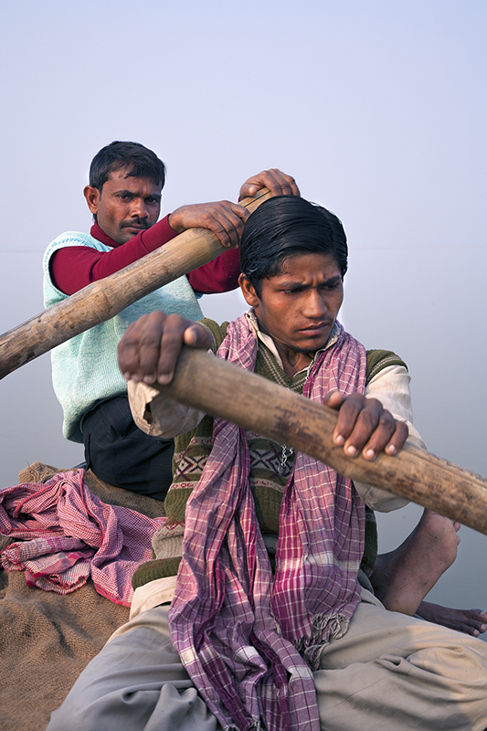 "Boatmen on Ganga Bhagalpur, Searching for endangered, bottlenose dolphins" by Joan K. Sharma.