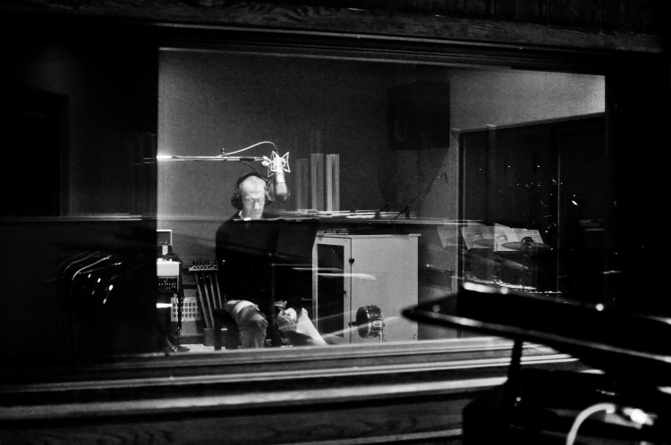 Philip Levine behind glass in the studio