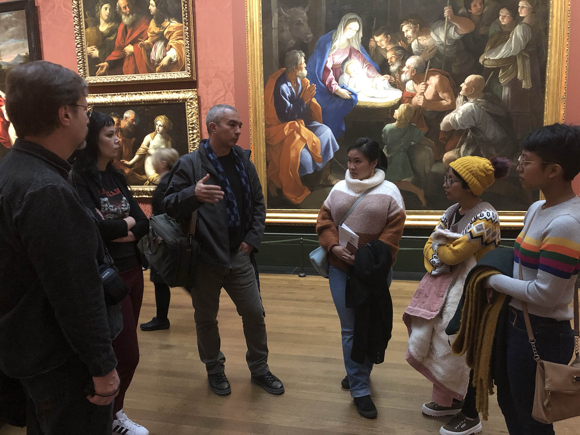 Professors Potter and Maldonado speak with students in the vast Italian Renaissance masters room.