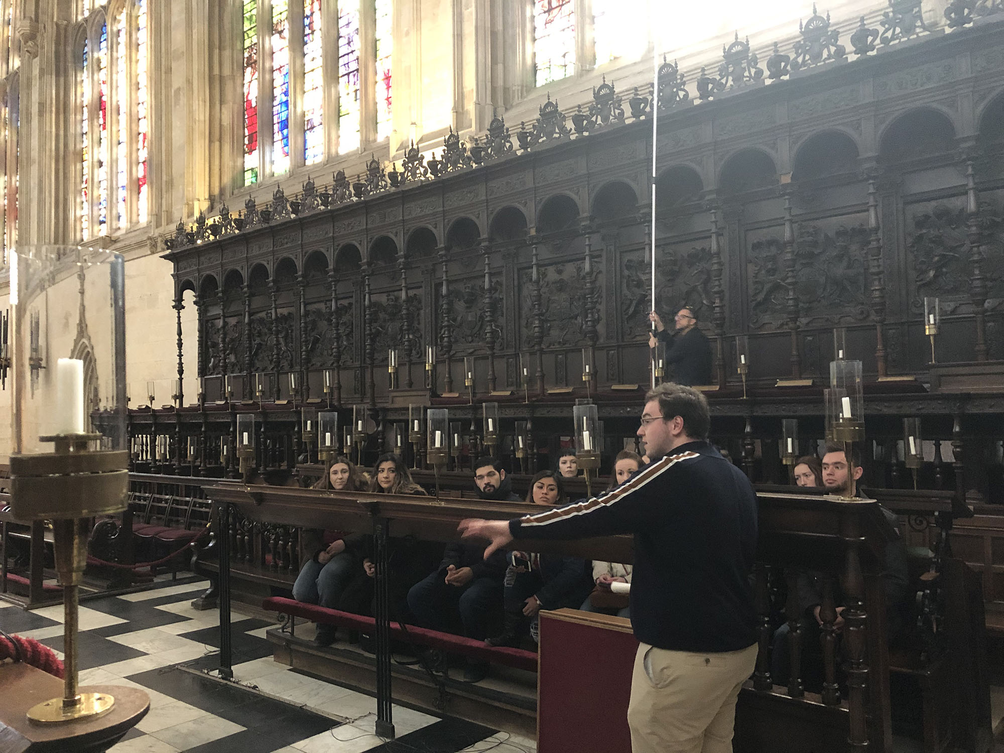 Students seated in the choir stalls at King’s College Cambridge to listen about the choir at the Chapel.