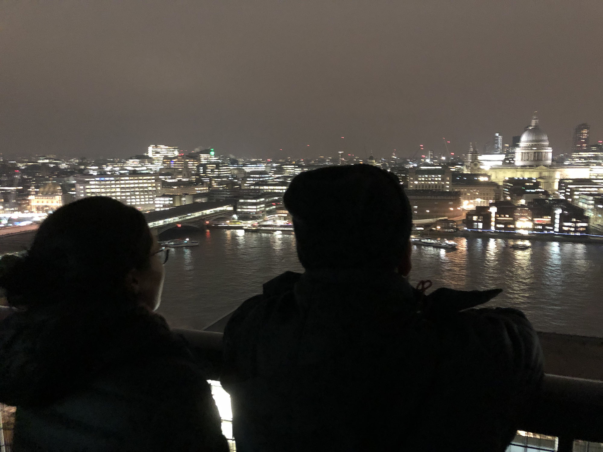 Students Victoria and Alejandro look out over the Thames at St Paul’s from the top of the Tate Modern Museum.