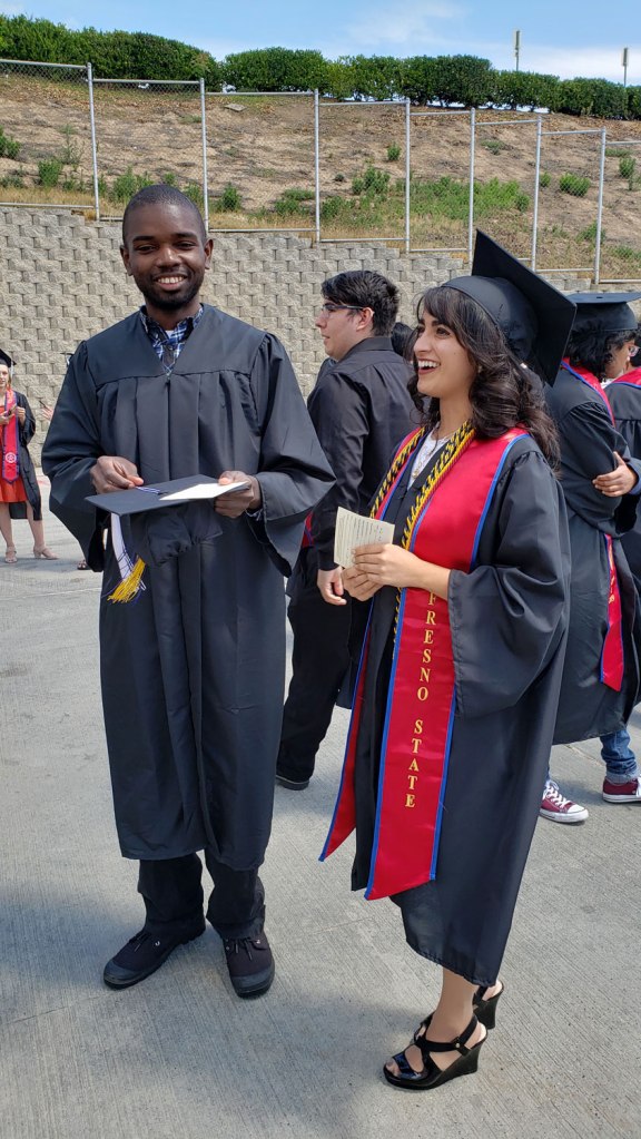 Tessa Barretto (left) talks with a fellow CAH student as they wait to be let in for convocation.