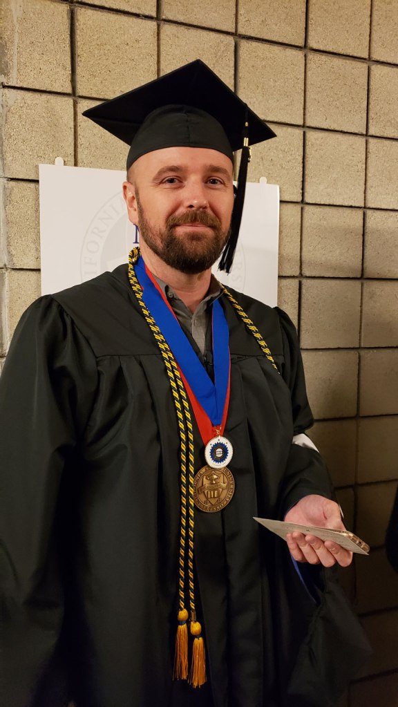 Dean's Medalist Mason Lamb lines up in the hall ahead of the CAH Convocation.