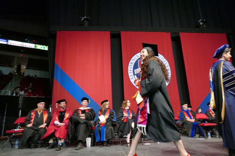 Dean's Medalist Primavera Leal Martinez receives her Bachelor of Arts in English. Martinez was later awarded the President's Medal during Commencement.