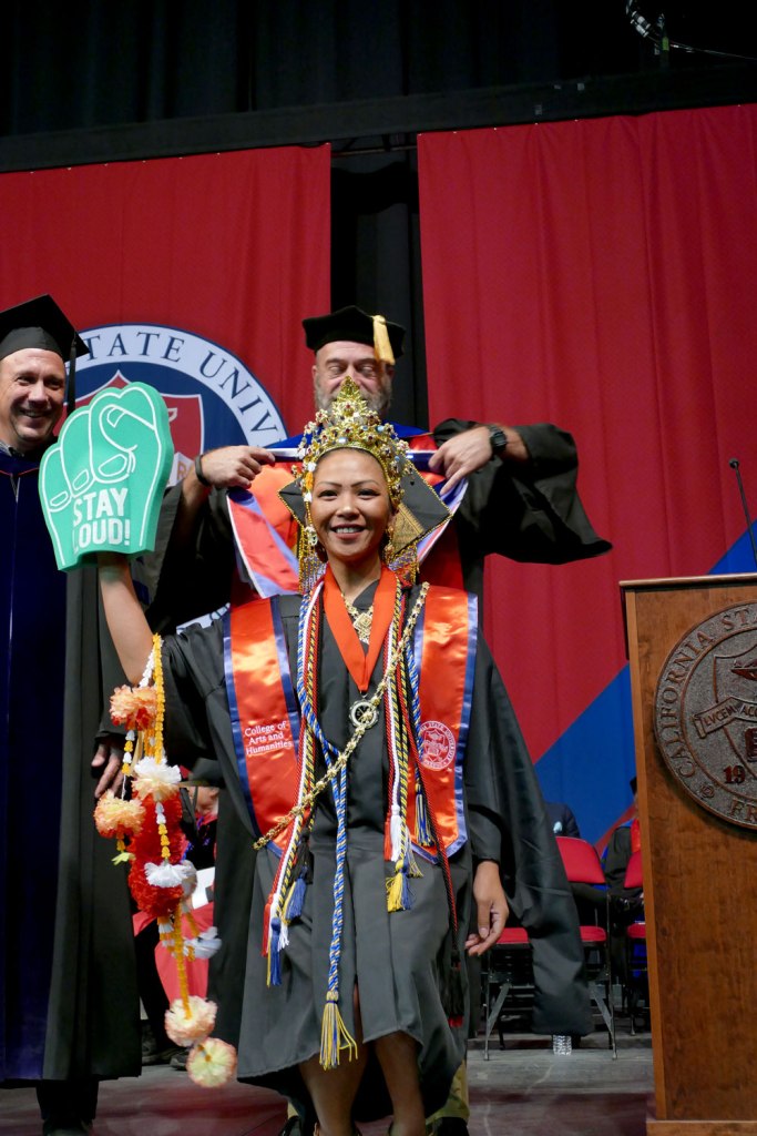 CAH student receives her Master of Arts hood.