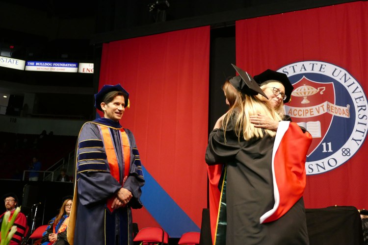 Theresa Lopes gets a big hug from Associate Dean Dr. Honora Chapman.