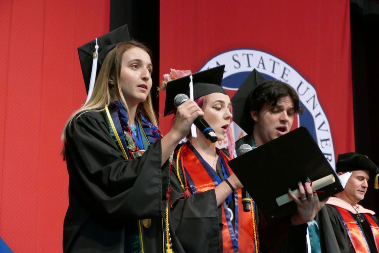 Theresa Lopes, Kenneshae Murray and Christopher Rodriguez sing To Thee Our Alma Mater.