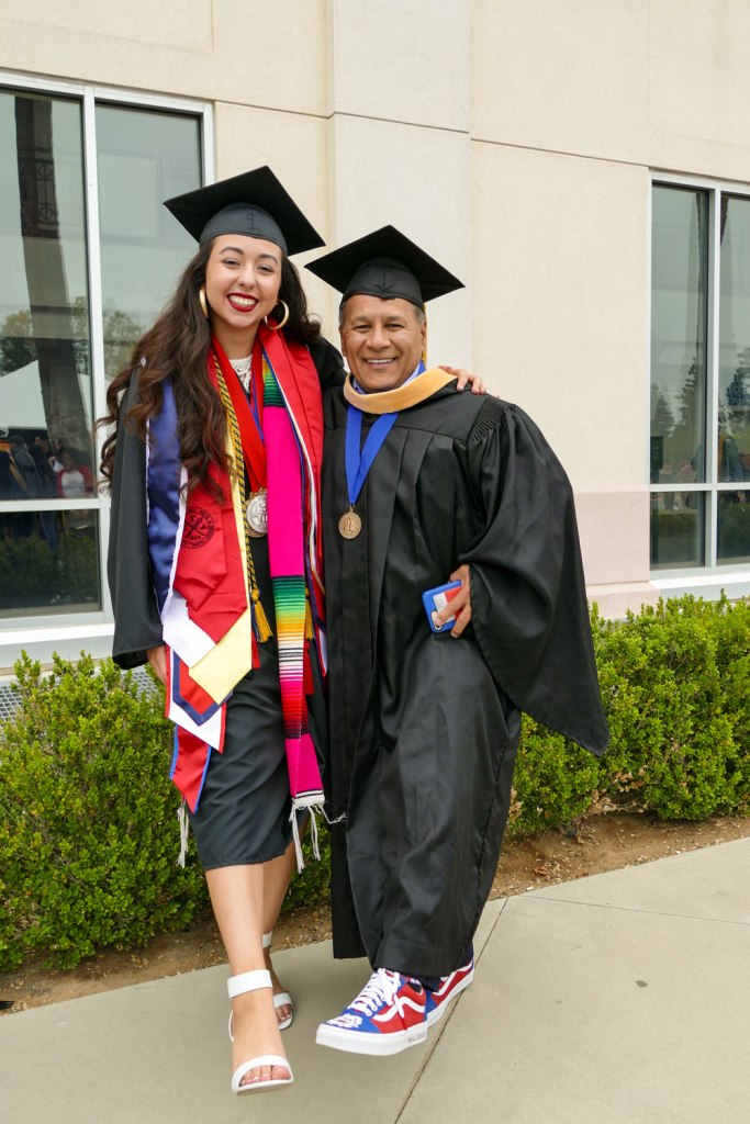 Primavera Leal Martinez and Fresno State's Executive Director of Governmental Relations Larry Salinas compare shoes.