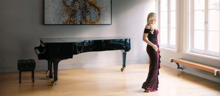 Natasha Paremski in a room with a grand piano. by Clarence Chan