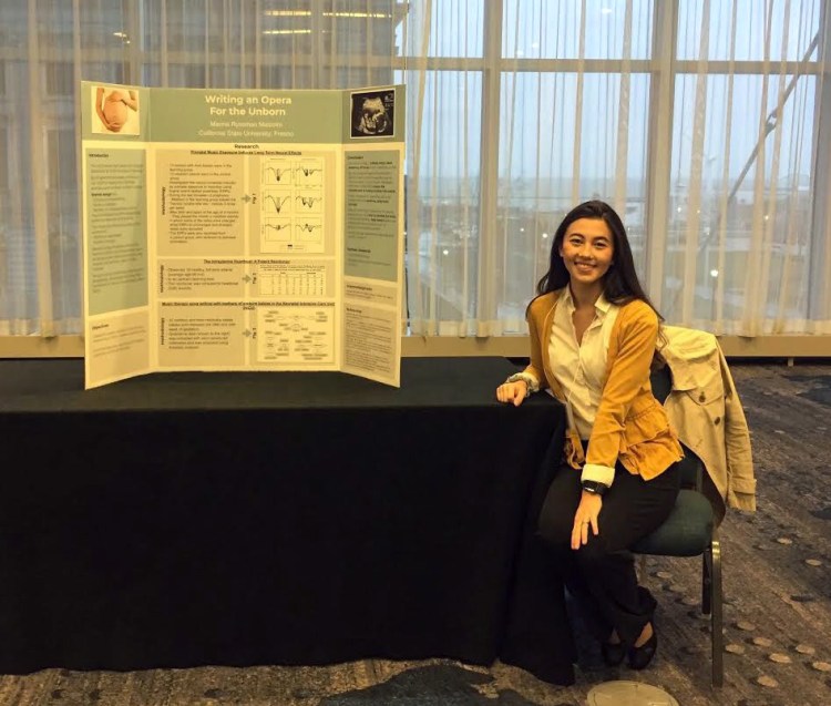 Marina Malcolm sits next to her presentation