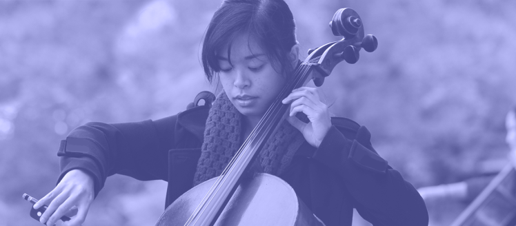 Arts in Motion Showcase - March 22-28. Cello player in front of music building.