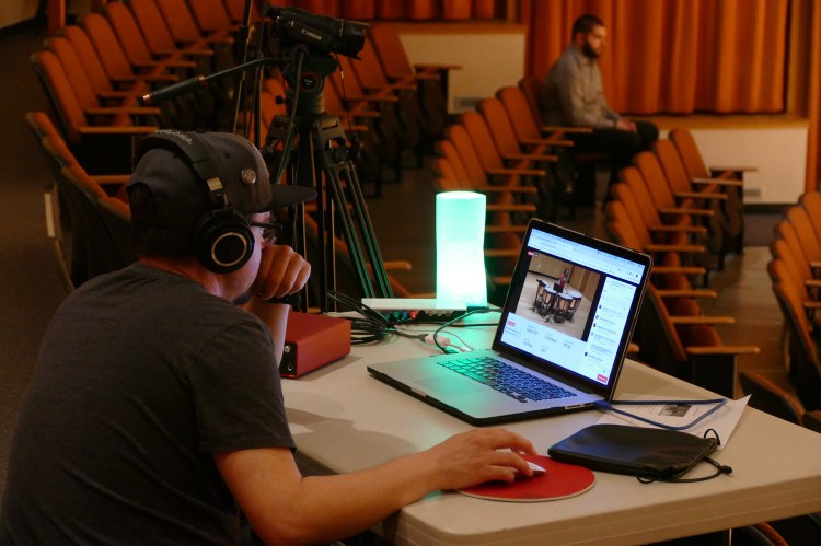 Performing arts technician Jose ElaGarza runs the virtual performance on Facebook Live.
