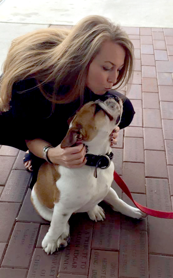 Jennifer gives love and kisses to Victor E. Bulldog (pre-COVID-19)