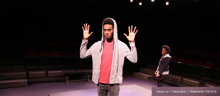 Student Joshua Slack has his hands up in the 2016 production "Hands Up: 7 Playwrites, 7 Testaments
