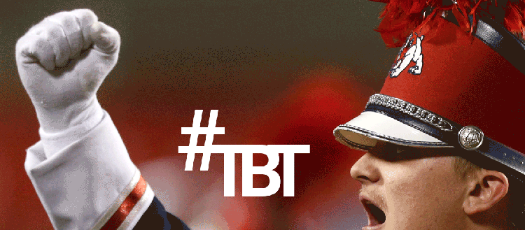 #TBT Throwback Thursday - Image of a Bulldog Marching Band Member in uniform holding his fist up.