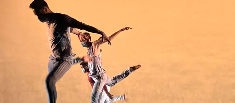 "We Can Work Alone" dancers on stage wearing COVID-19 masks