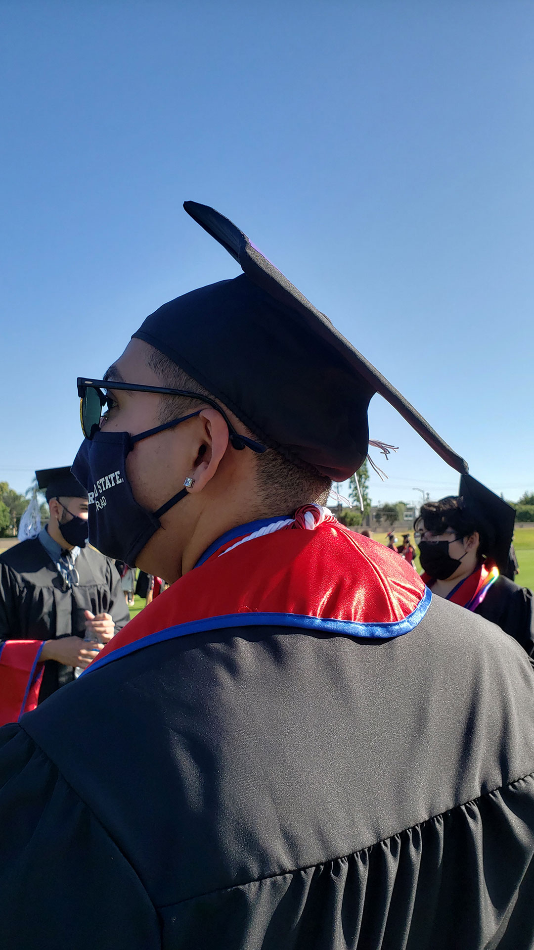 Student in mask and grad cap.