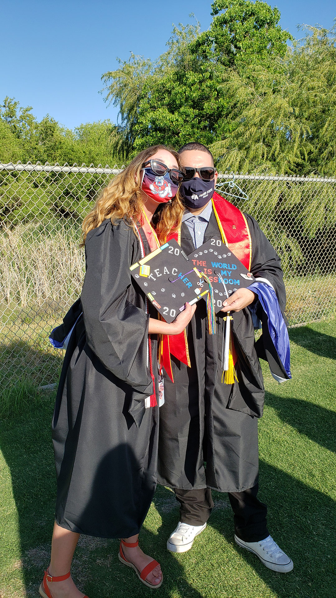 Grads show off their cap decorations.