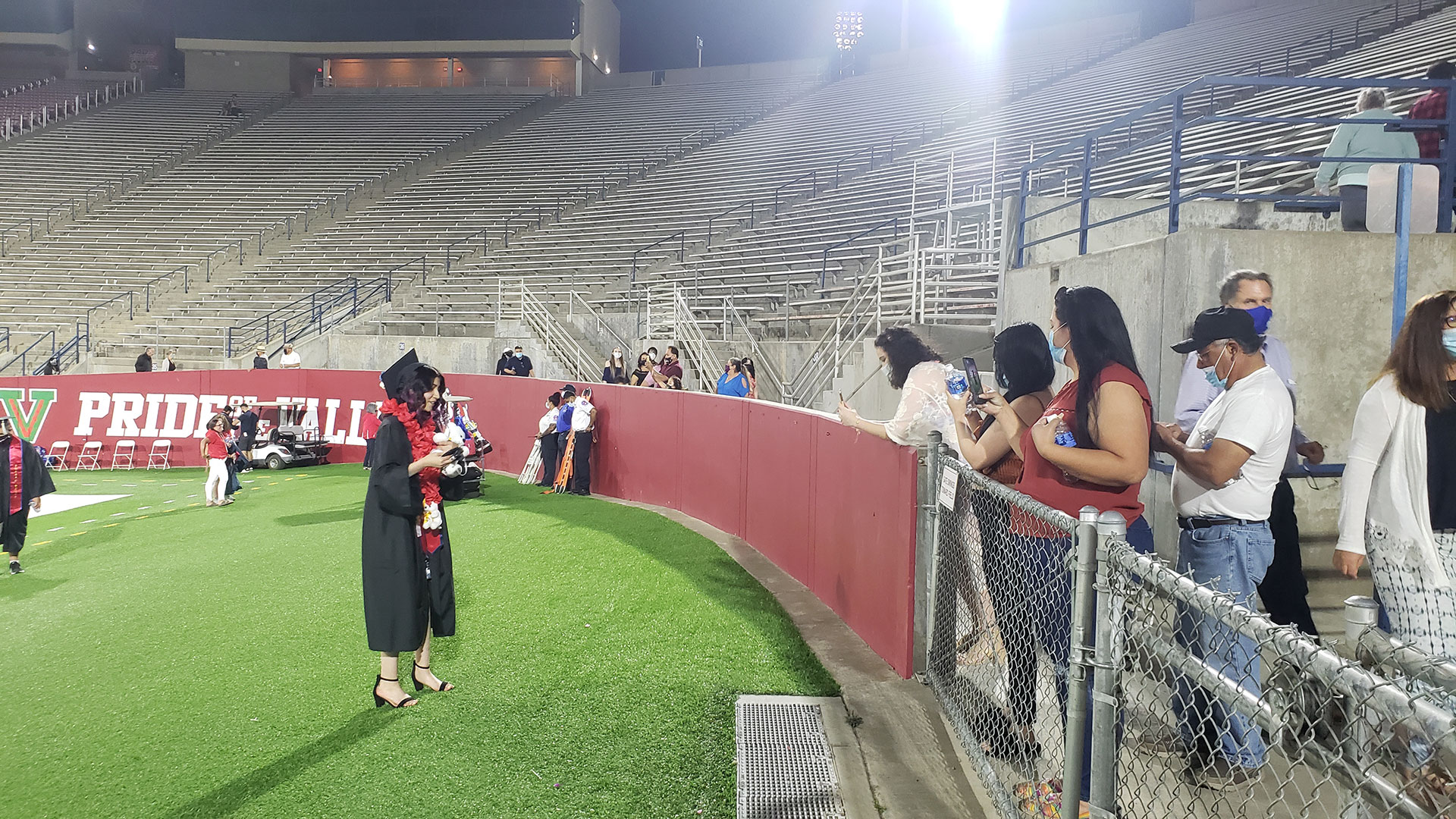 Student talks to her family after commencement.