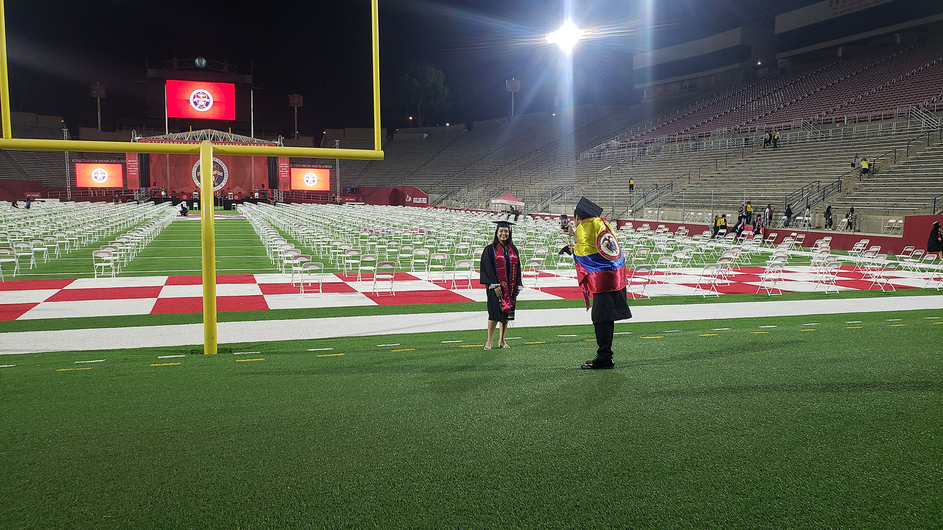 Students take photos after commencement.