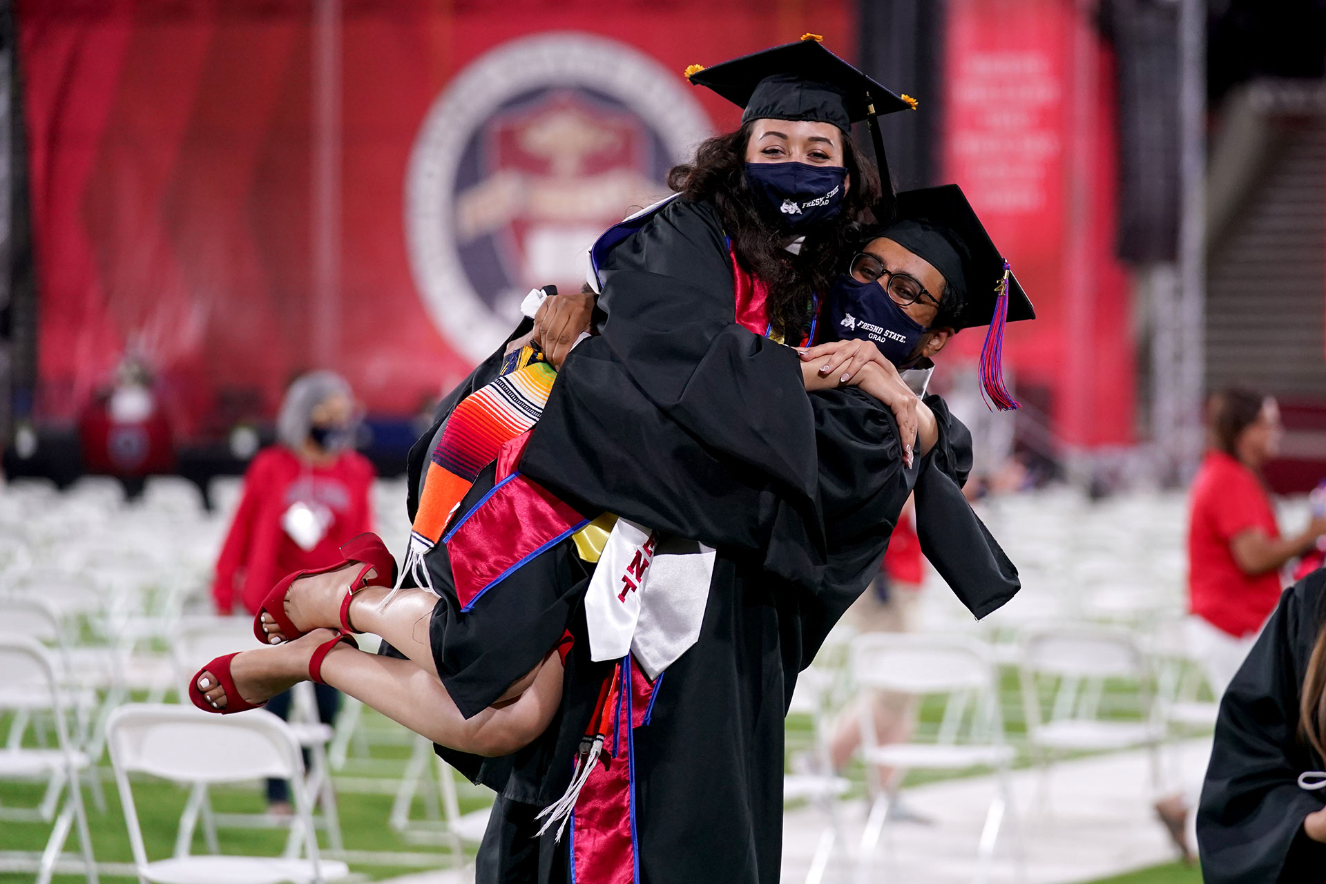 Two graduates hug each other.