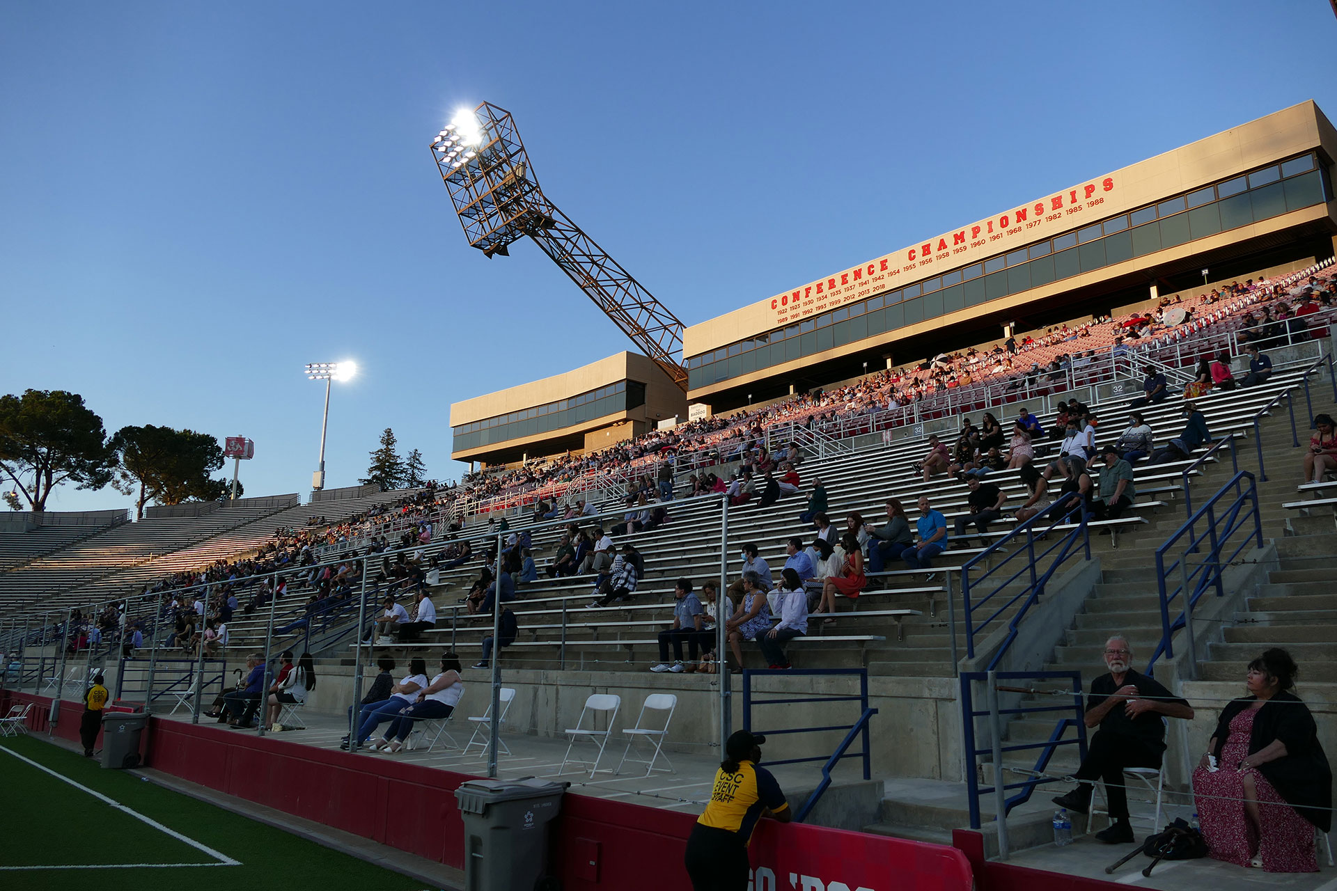 Family, friends and loved ones watch in socially distanced pods of four during the in-person commencement.