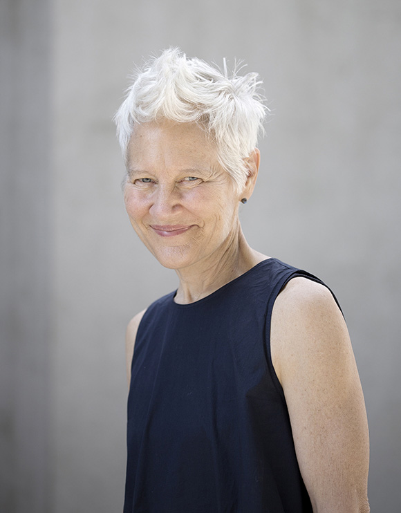 Photo of visual artist Ann Hamilton on a grey background.