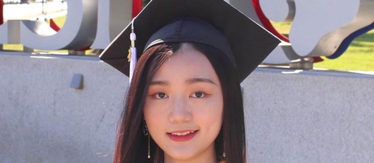 ShuYee is posing in front of Fresno State.