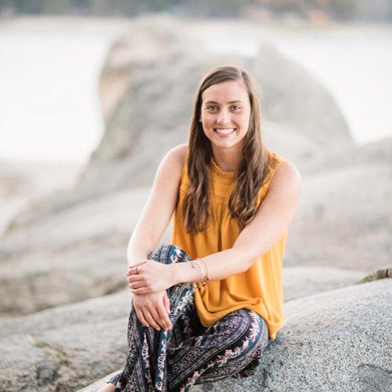 Alexia Beck sits in front of a lake.