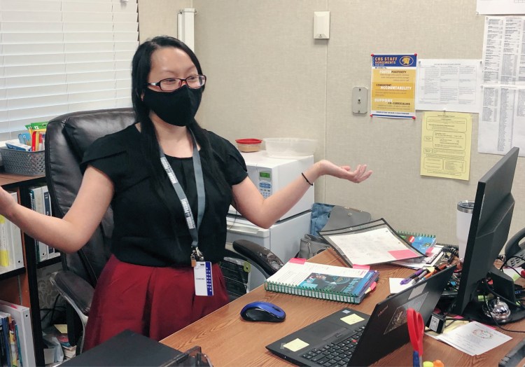 Lor is inside her office, working.