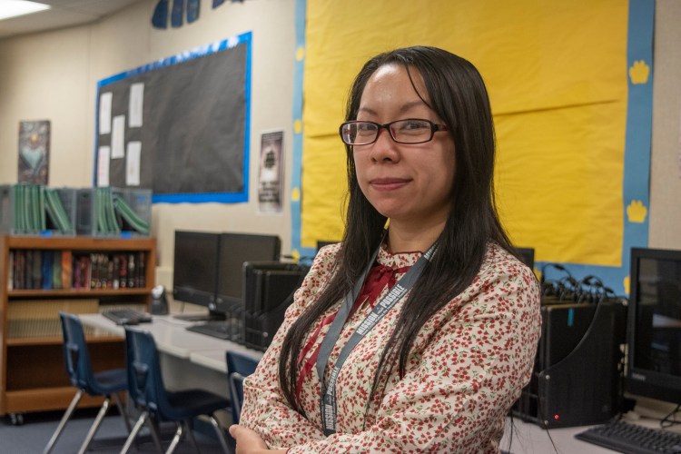 Lor poses with computers behind her in he background.
