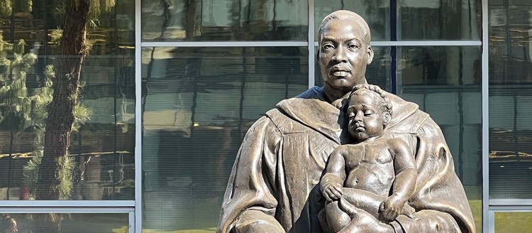 Martin Luther King, Jr. statue holding a young child in the Fresno State Peace Garden.