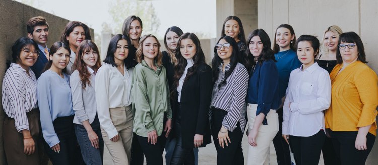 Group photo of the Class of 2022 interior design students on the Conley Art building balcony.