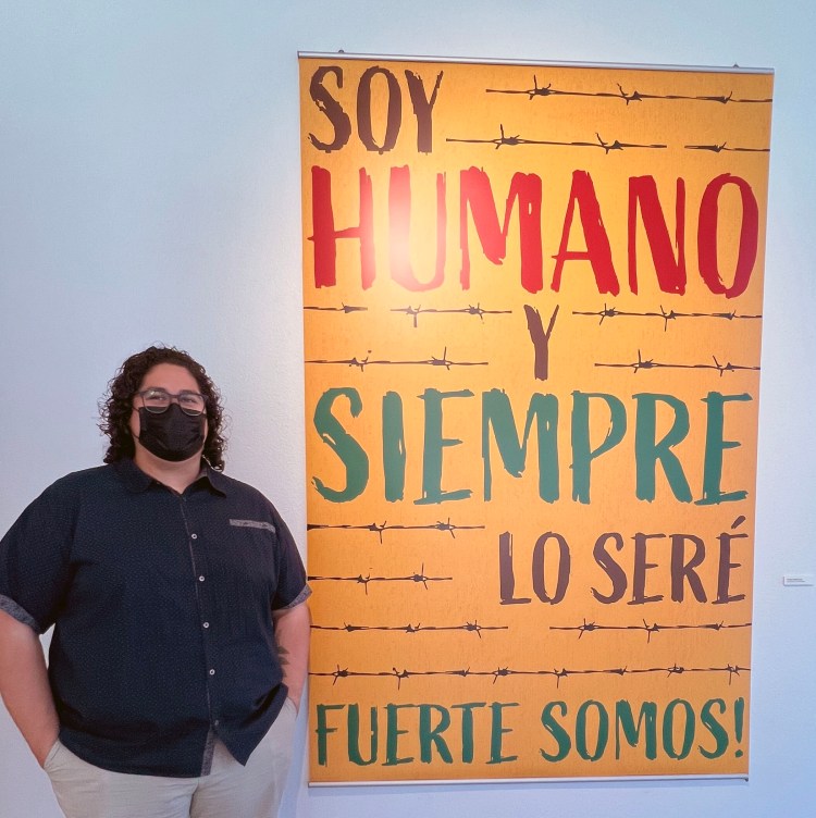 Christian Rafael stands by his “Soy Humano/I Am Human” poster.