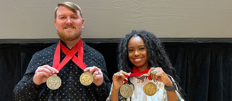 Steven Hensley and Audia Dixon hold their Dean's Medals and President Medals.