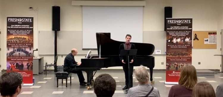 Piano accompanies a singer performing an original piece at the Art Song Festival.