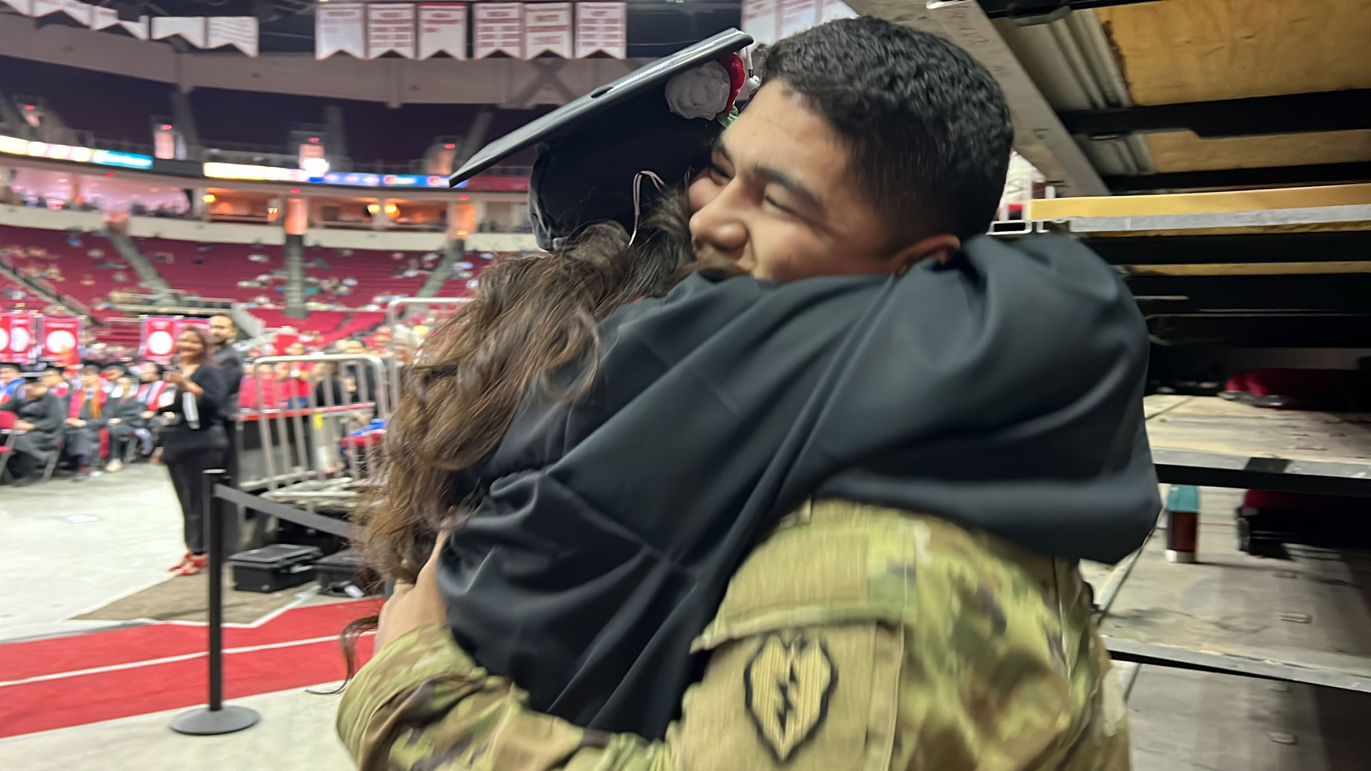 Interior Design graduate Lorena Seijas hugs her son, soldier Piero Accinelli who surprised his mom for her graduation.