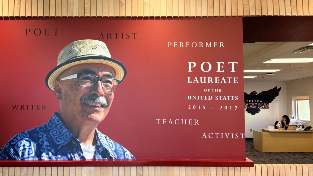 A mural inside the administration office with a photo of Juan Felipe Herrera and the dates as a Poet Laureate.