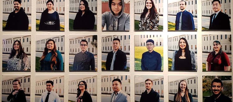 Graphic design student photos on a wall during an exhibit.