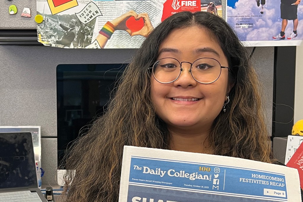 The Collegian's Editor-in-Chief Jannah Geraldo holding a copy of the newspaper