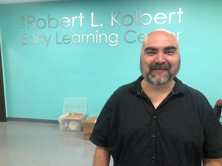 Tyner is standing in-front of the Robert L. Kolbert Early Learning Center.