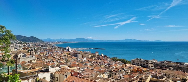 The image shows the beautiful city of Salerno and its coastline. The vast blue waterbody can also be seen.