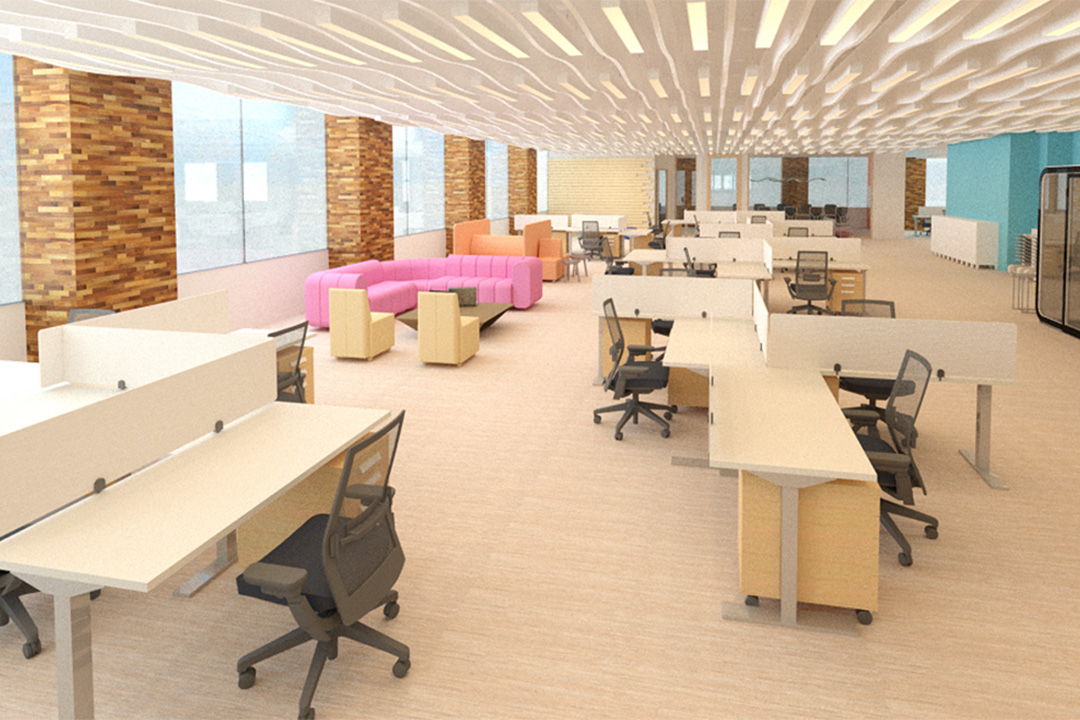 the big open office shows multiple pale colored desks with black chairs. the room also consists of a big pink couch in the middle, attached to the wall.