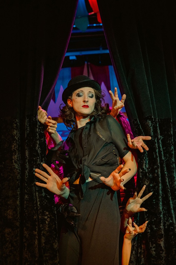 Actor is seen performing with full makeup and costume for Pippin.