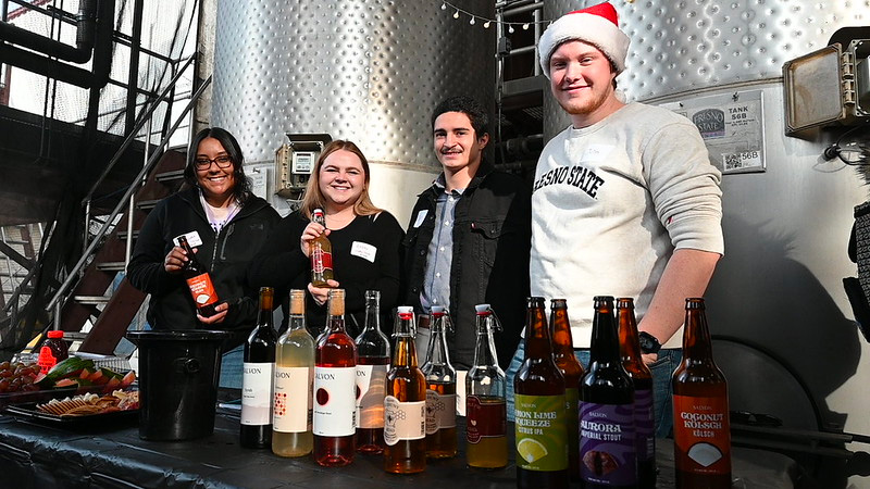 Students show off their wine and beer products.