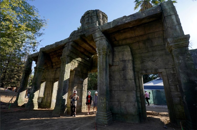 Dr. W. Saam Noonsuk and students walk through the intricate remnants of an ancient Cambodian temple recreated at the Fresno Chaffee Zoo.